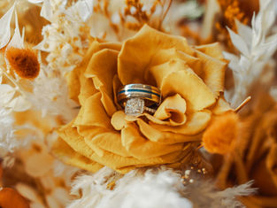 wedding rings inside of the bride's bouquet