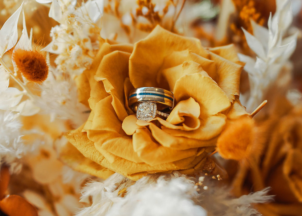 wedding rings inside of the bride's bouquet