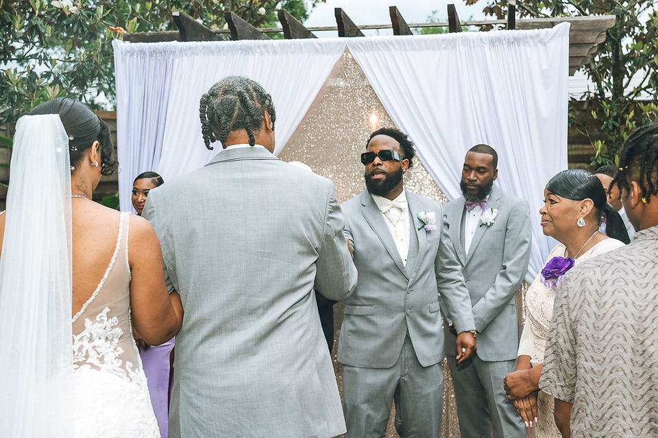 Bride’s father handing her off to the groom during the ceremony