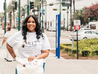 Moore Life & Travel branding photo of Regina Moore at the end of Canal Street in New Orleans.
