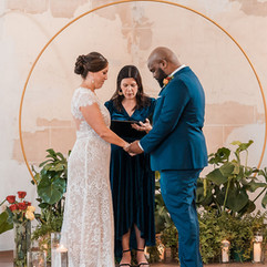 bride and groom holding hands while exchanging vows