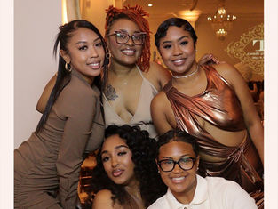 Five smiling people pose in elegant attire at an event. Warm lighting, floral border, "Lorielle & Darrin, May 9th, 2025" text visible.