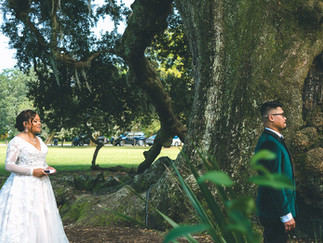 Wedding video still of a bride and groom sharing a first look at the Tree of Life in Audubon Park