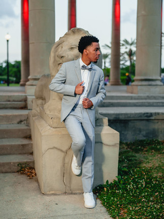 Teen boy prom portrait posing in front of a statue at City Park Peristyle