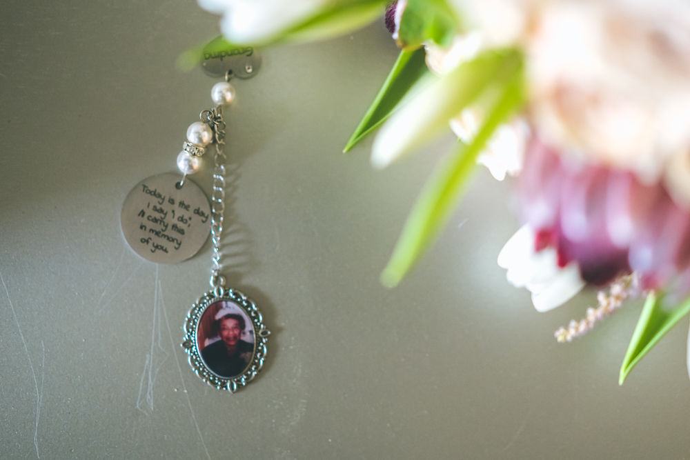 Close-up of Ramonica’s wedding bouquet and memorial charm