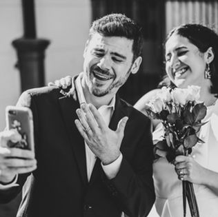 Joseph and Sylvia FaceTiming family while showing their just married wedding rings
