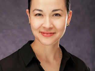 Professional studio headshot of a Latina businesswoman in New Orleans.