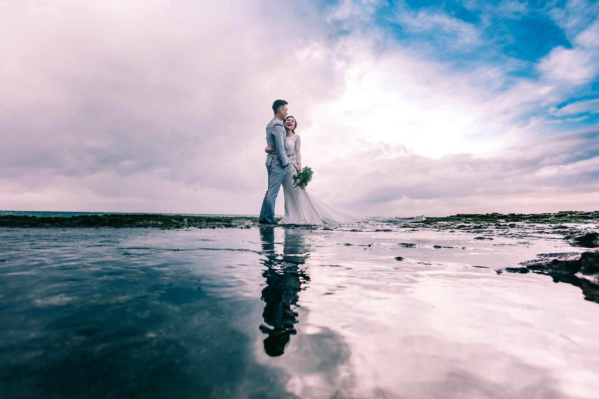Wedding couple wide pose on beach