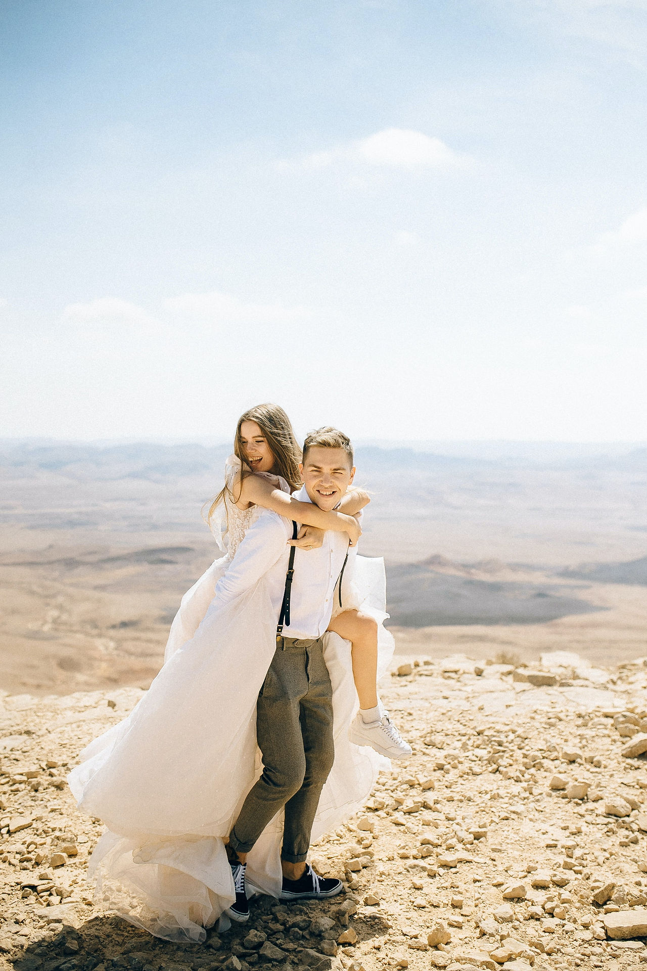 Wedding couple action pose piggy back ride