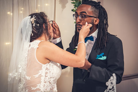 New Orleans wedding Couple feeds each other during cake cutting