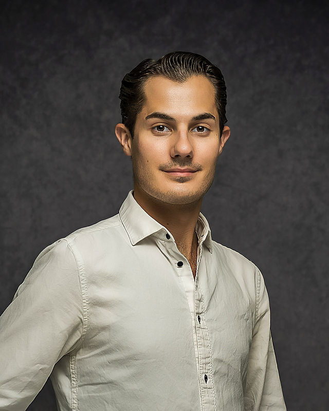 Polished studio headshot on neutral backdrop