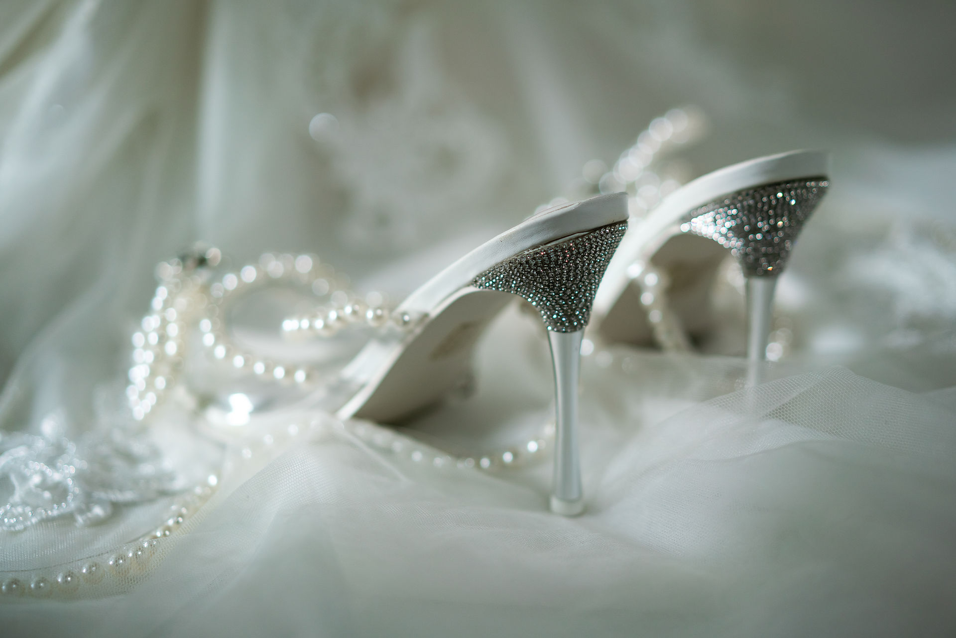 Close-up of wedding gown details and shoes during bridal preparation