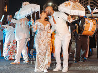bride and groom kiss at new Orleans secondline