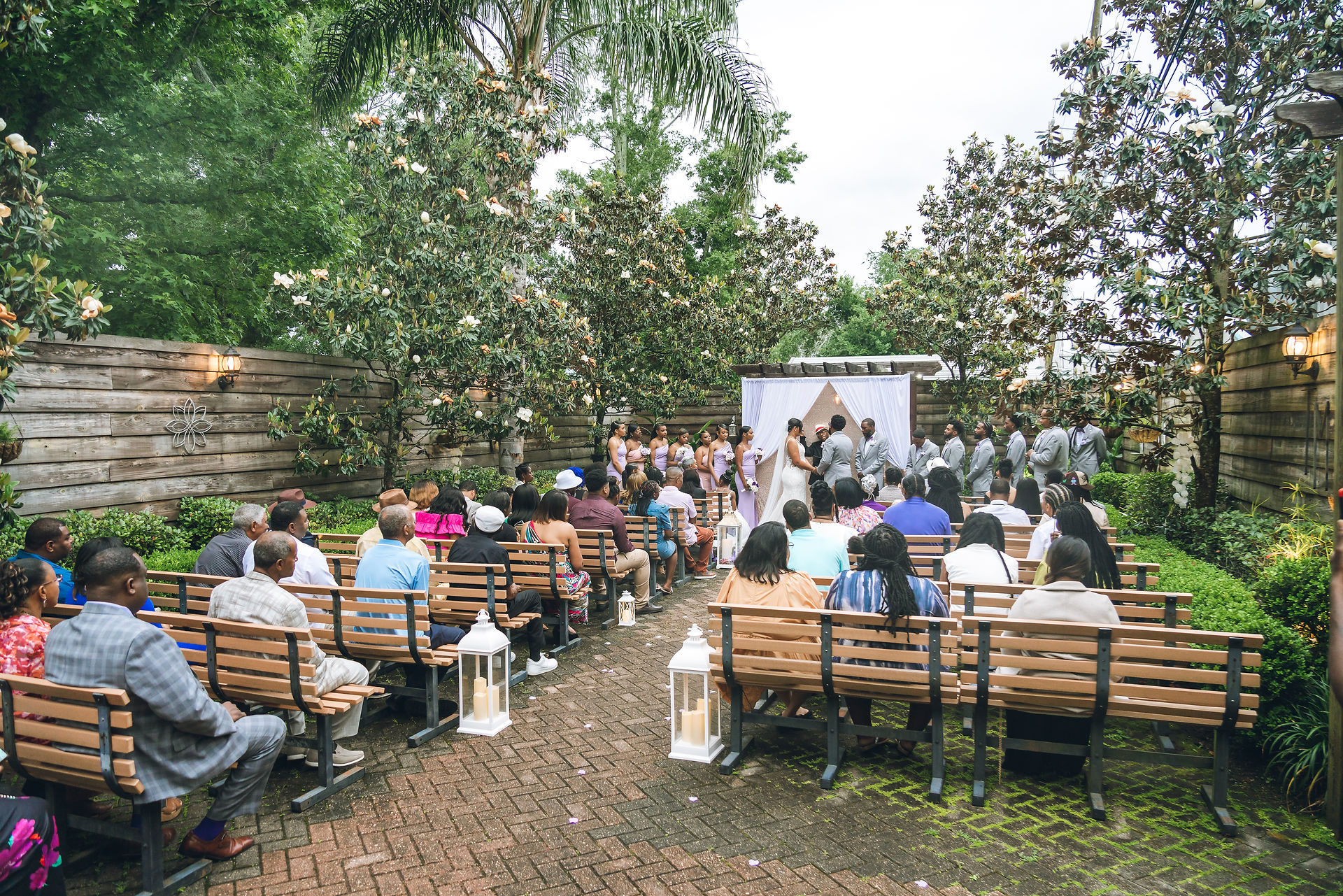 New Orleans wedding photographer and videographer - couple exchanging cows in front of friends and relatives