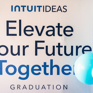 INTUIT IDEAS graduation banner reading Elevate Your Future Together with blue and white balloons.