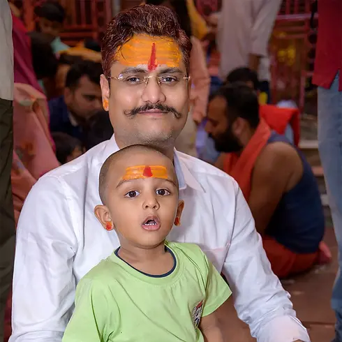 Client Sujeet Kumar with his son at his son’s Mundan Ceremony at Baidyanath Dham Temple, Deoghar — captured by Ranjan KM’s Photography, trusted Deoghar photographer for religious and family functions