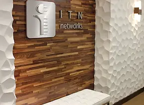 The redesigned lobby and conference room feature a integration of acoustic tiles, designed with a unique pattern that enhances both aesthetics and functionality. The tiles are a sophisticated look but also improve sound absorption, creating a more comfortable environment.