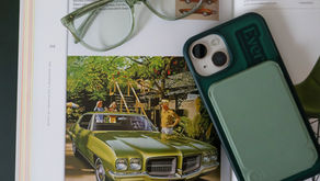 My green phone and glasses resting on an open page of a book
