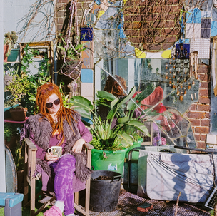 Eccentric woman sitting in her garden