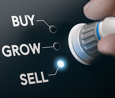Hand turning a knob to select buy, grow or sell Concept of buying, developing and selling