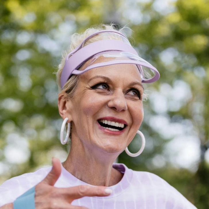happy-senior-woman-exercising-outdoors-with-a-resistance-band-sitting-on-a-park-bench_edit