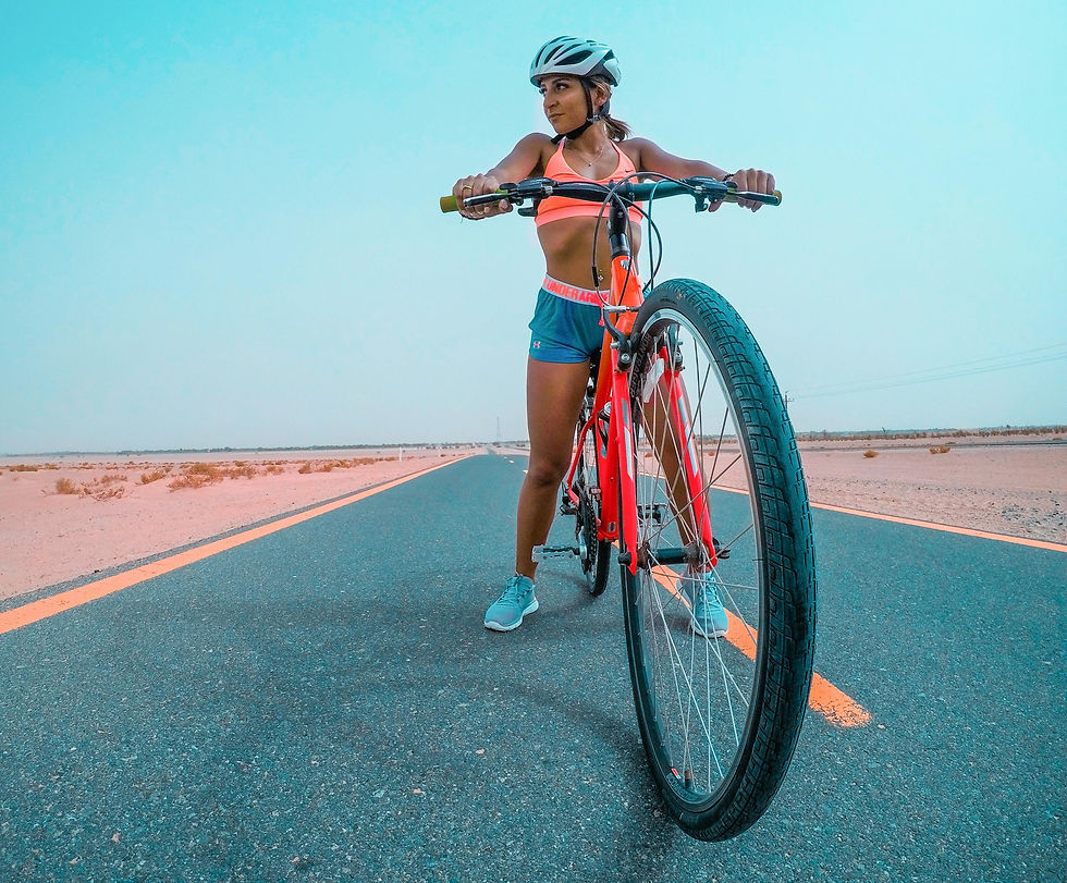 a-woman-cyclist-in-athletic-gear-on-a-bike-in-the-dubai-desert-promoting-fitness-and-adven