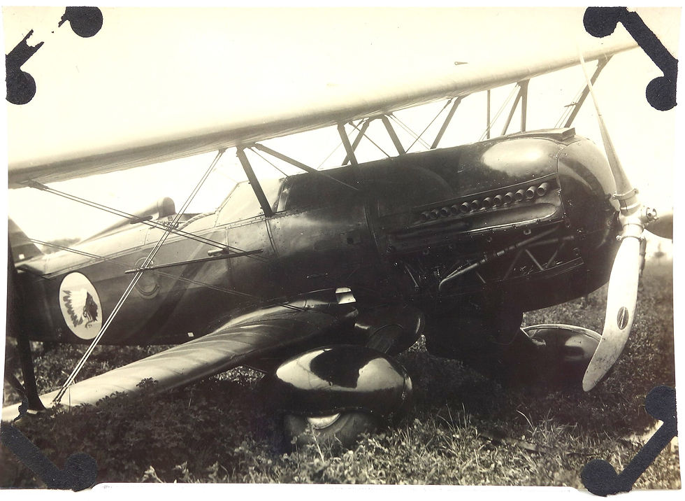 Black and white photo of a vintage biplane