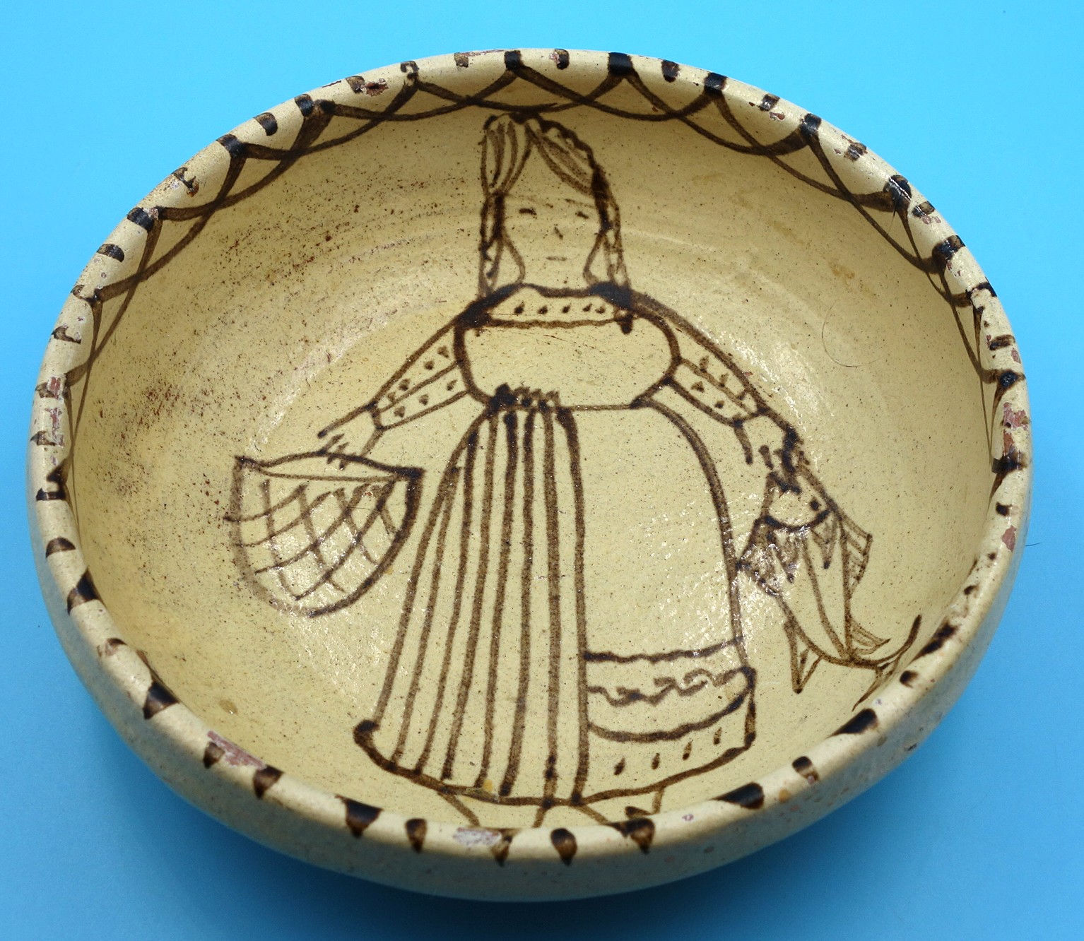 Pre-Columbian ceramic bowl depicting a woman with fish