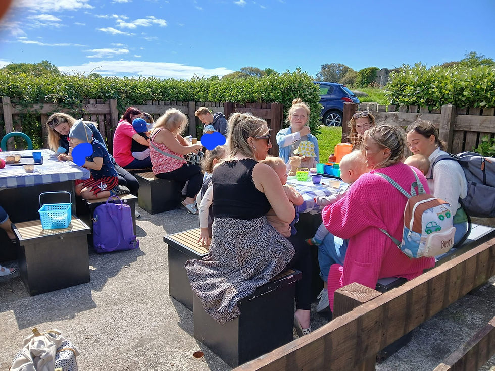Adults and Toddlers sitting outside, enjoying the sun