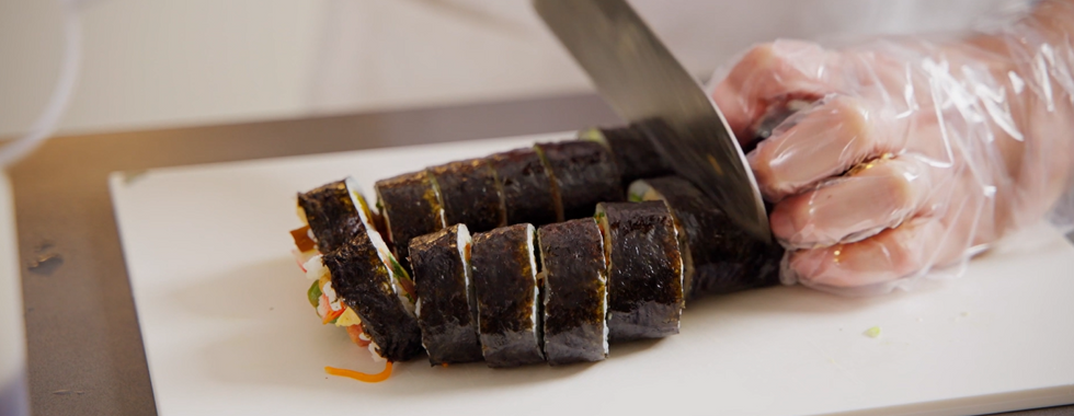 Sliced kimbap pieces arranged neatly on a plate.
