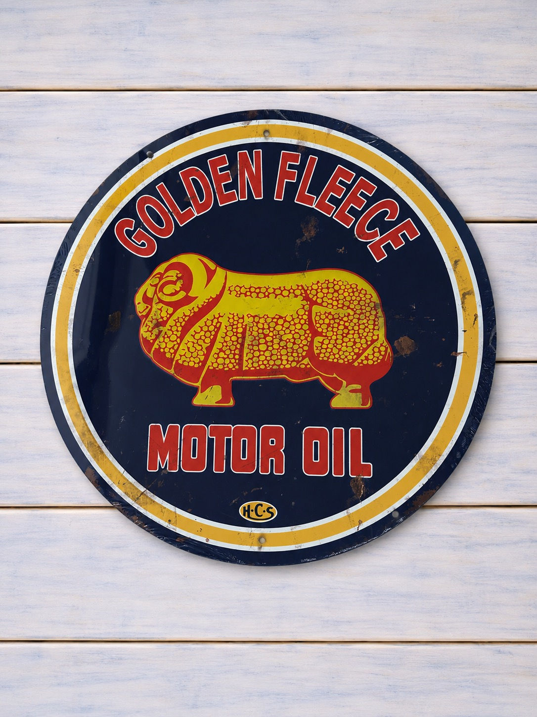 60 cm round Golden Fleece Motor Oil sign with yellow ram artwork, red lettering and a dark blue background