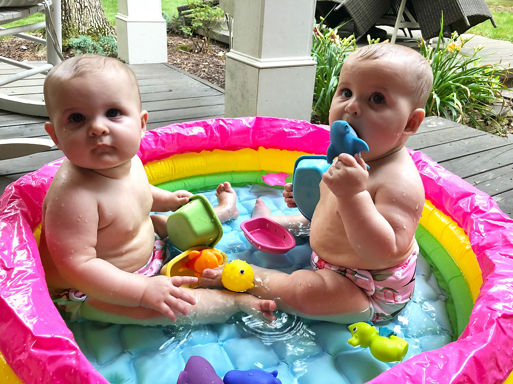 twin girls in inflatable pool