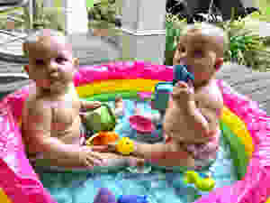twin girls in inflatable pool