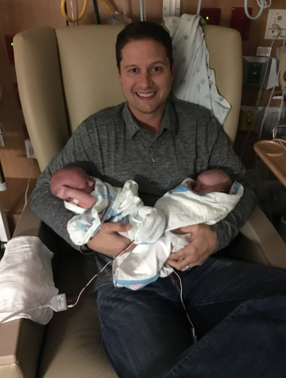 husband holding both babies