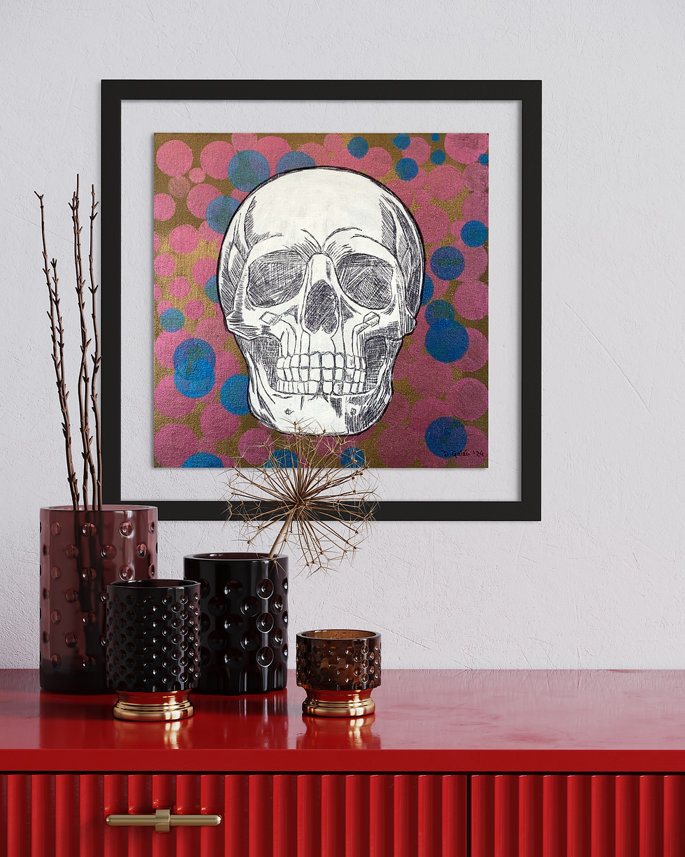 Skull art piece on wall, skull image. Candles and decoration on table.