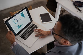 Businessman reviewing financial data on laptop