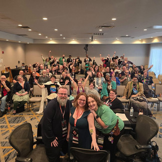 A picture of a room full of people, the closing ceremonies at Multiverse Con