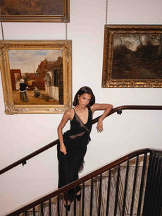 Influencer posing on a grand staircase at a Kerastase influencer activation, photographed by London events photographer Margot Jakobson, combining fashion, beauty and a gallery-style interior.