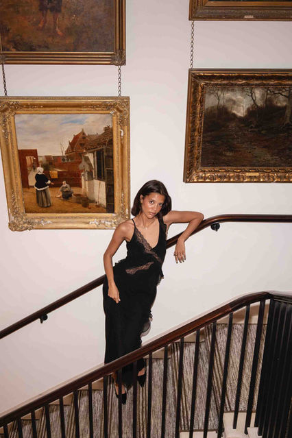Influencer posing on a grand staircase at a Kerastase influencer activation, photographed by London events photographer Margot Jakobson, combining fashion, beauty and a gallery-style interior.