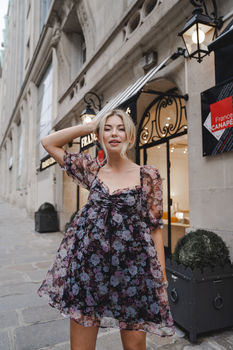 London-based Margot Jakobson photographs Georgia Toffolo in a flowing floral dress on a picturesque Parisian street. This stylish street-style shot highlights urban and sophisticated fashion.