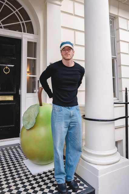 Guest posing outside Jo Malone London townhouse beside pear installation at English Pear & Sweet Pea launch event, celebrating with Georgia-May and Lizzy Jagger, photographed by Margot Jakobson.