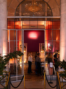 Elegant Maybelline x SheerLuxe event entrance with chandelier-lit venue and guests arriving for the Luxegen launch, captured by brand activations photographer Margot Jakobson.