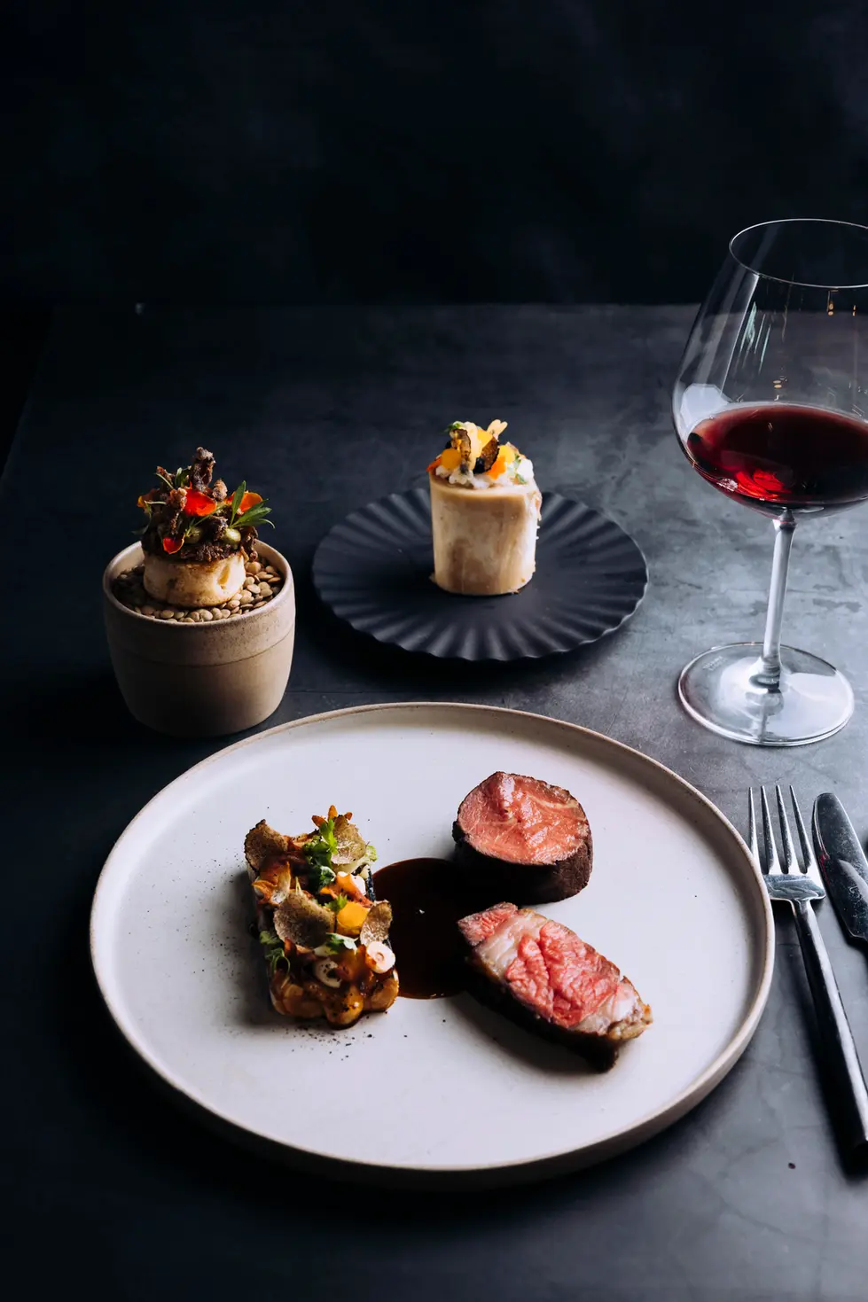 Slow-cooked 24-hour Yorkshire feather blade and sirloin Wagyu, served with stuffed leek, truffled cauliflower cheese rarebit, Marmite, toasted hazelnuts, and a crispy finish, an exquisite dish perfect for fine dining and upscale events.