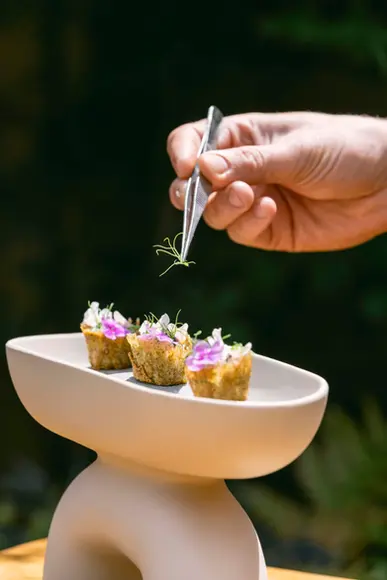 Caramelised artichoke velouté served with farro, pickled garlic, and a rich coffee reduction, a sophisticated dish perfect for upscale events and gourmet dining experiences.