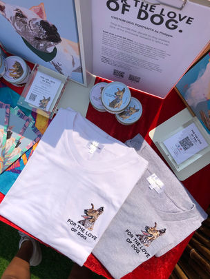 A layout on the table of dog themed products and merchandise for sale to raise funds for a local animal shelter.