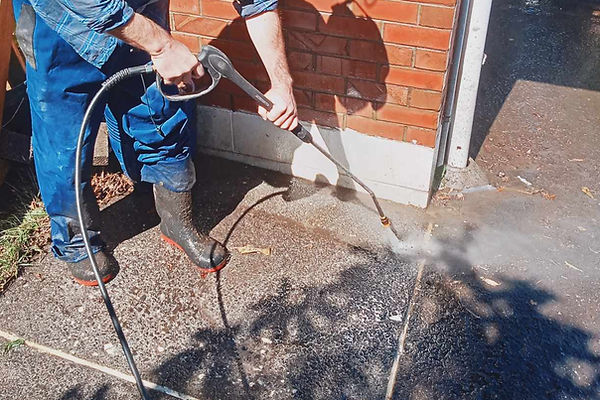 Scrubby McTubb water blasting an Auckland pathway.