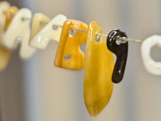 Hand-sculpted and hand-glazed shell letters by designer Linda Clarini – shell jewelry.