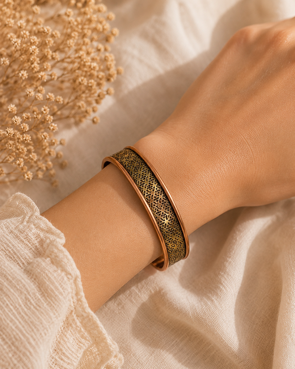 Bracelet en cuivre texturé sur un poignet.