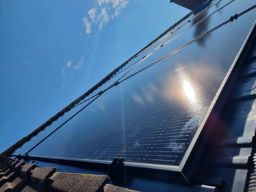 Solar Panels with sunshine on a roof in swadlincote