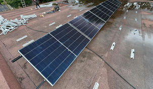 Some solar panels during installation on a flat roof